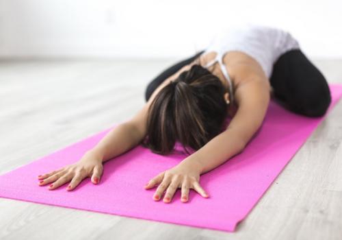 woman-doing-yoga-pose-on-pink-yoga-mat-374589
