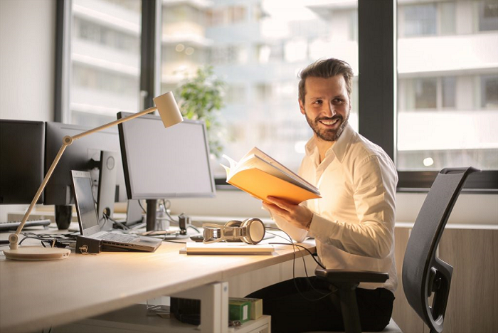 photo-of-man-holding-a-book-927022_Photo-by-bruce-mars-from-Pexels-700×468